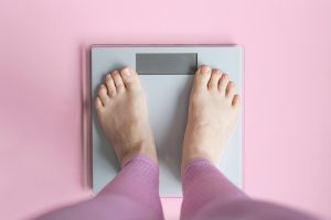 Woman watching her weight . Weight loss. Healthy weight.