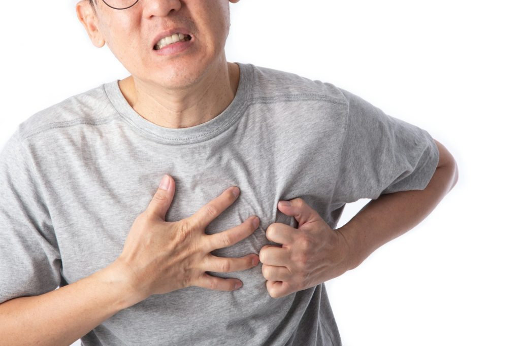 middle age man has a heart attack symptom.