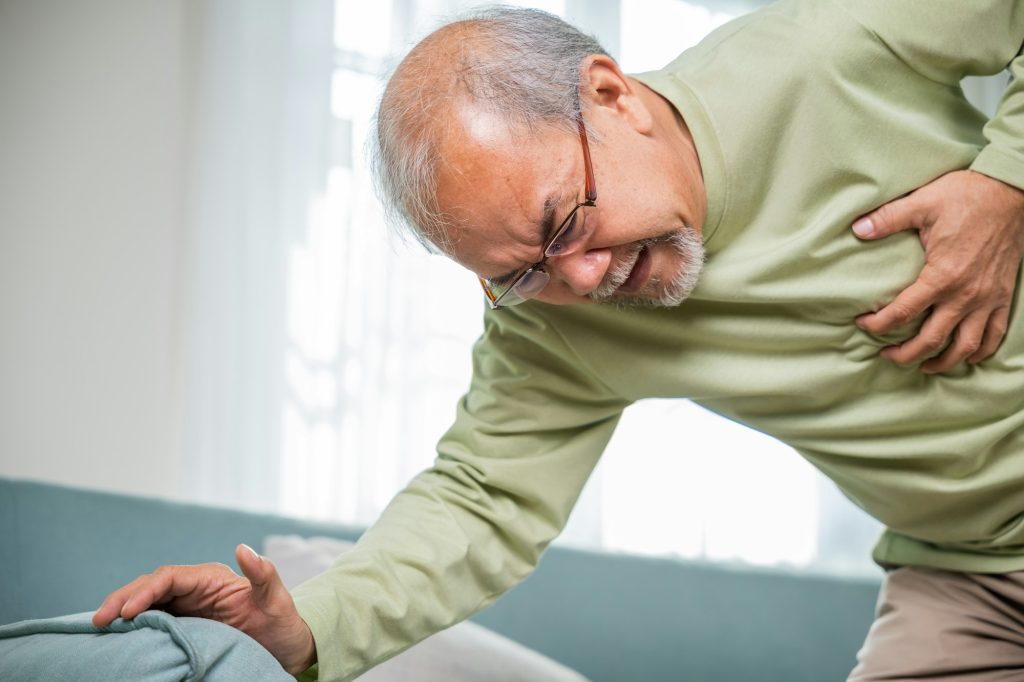 Sad senior man feeling bad pain use hand touching chest having heart attack